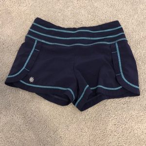 Purple Athleta shorts with blue stitching